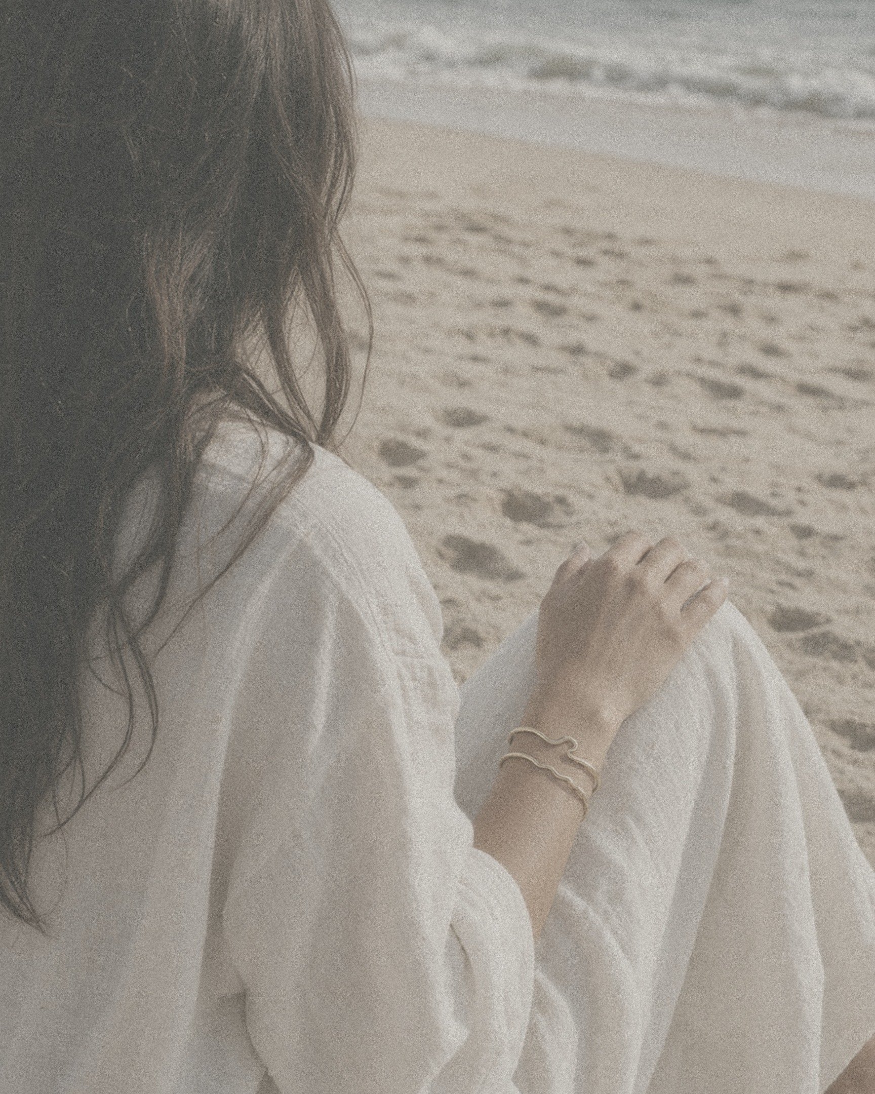 Gold-filled wave bangles worn on the beach